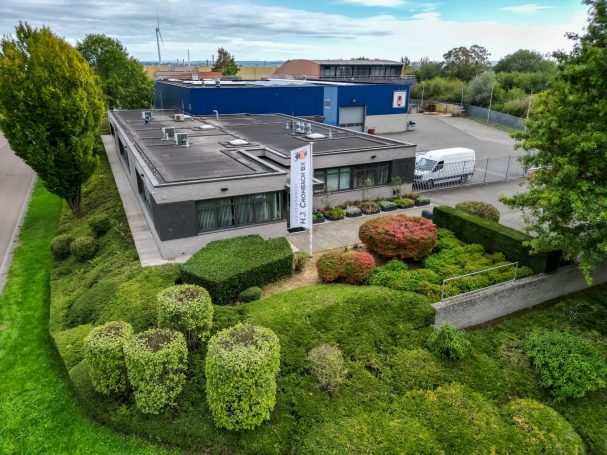 Luchtfoto van een bedrijfspand met omliggend groen